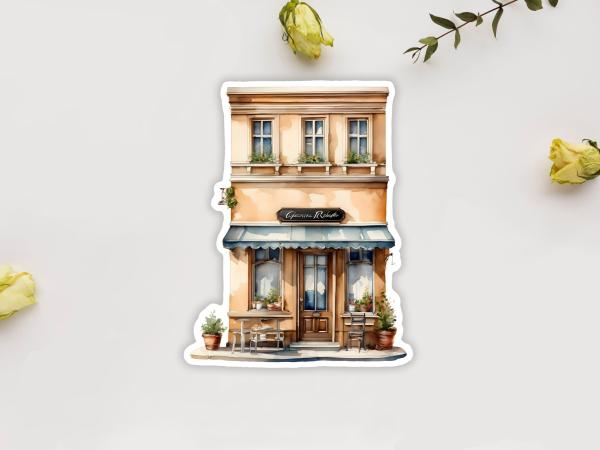 Sticker eines Cafés mit blauer Markise und kleinen Tischen im Freien. Die Fassade des zweistöckigen Gebäudes hat beige Farben und Blumenkästen an den Fenstern im oberen Stockwerk.